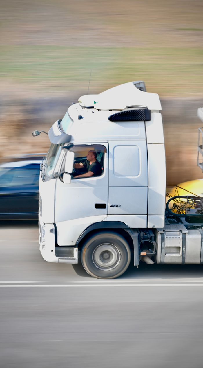 Home Dynamic shot of a white truck speeding on a highway in Agramunt, Spain.